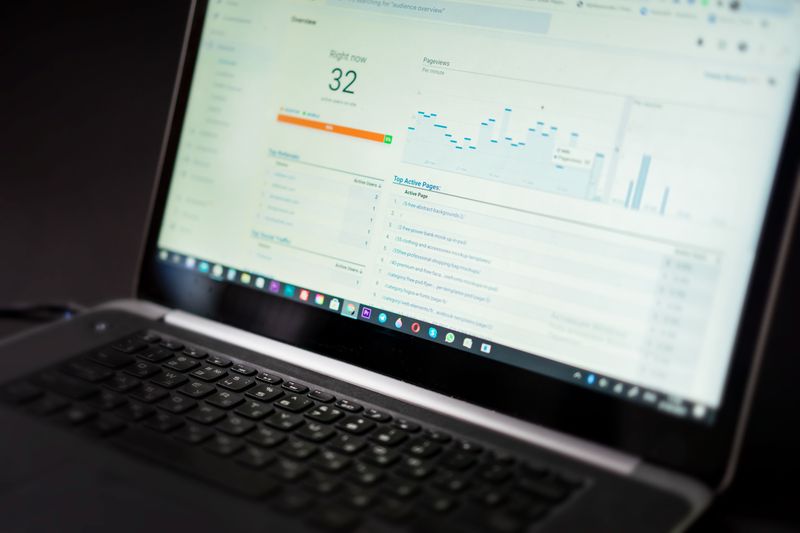 A laptop displaying an analytics dashboard with real-time data tracking and analysis tools